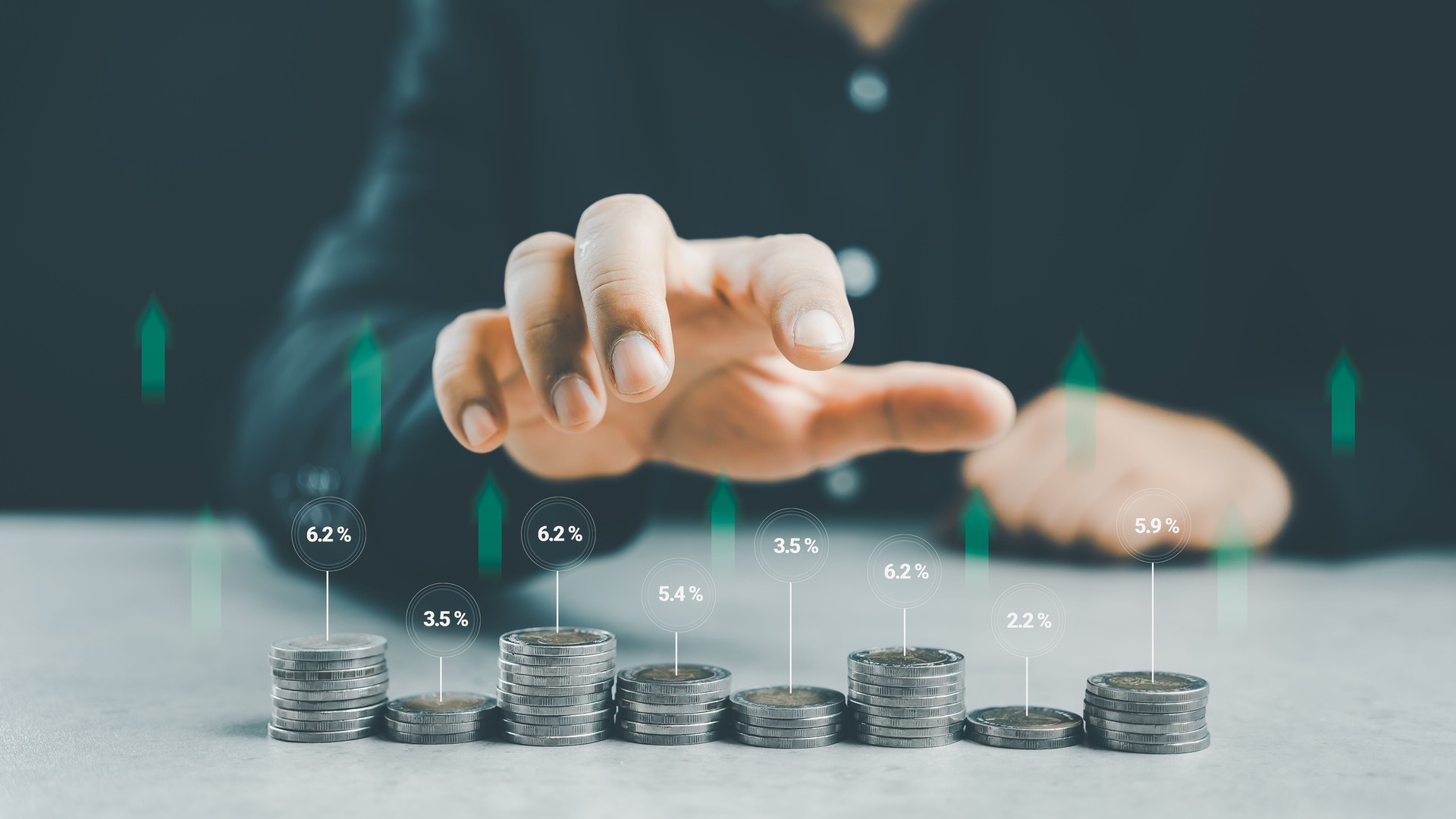 Stacking coins different heights with percentages for interest rates from different investment.